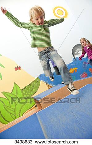 Children jumping over boxes, low angle view View Large Photo Image Stock Image - Children jumping over boxes, low angle view . Fotosearch