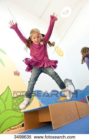Children jumping over boxes, low angle view View Large Photo Image Stock Photography - Children jumping over boxes, low angle view . Fotosearch