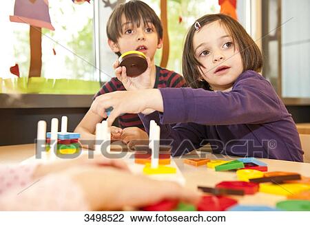 Children playing at a table, low angle view View Large Photo Image Stock Image - Children playing at a table, low angle view . Fotosearch