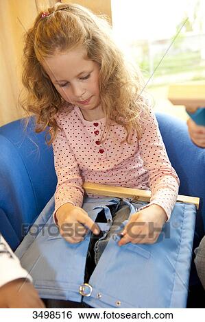 Stock Photograph - Children playing with fasteners, elevated view . Fotosearch