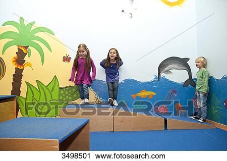 Children standing on boxes in a kindergarten View Large Photo Image Stock Image - Children standing on boxes in a kindergarten . Fotosearch