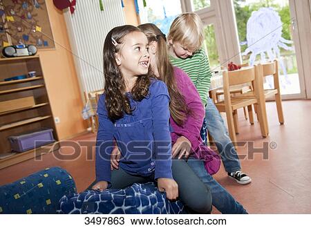Children swinging in a kindergarten View Large Photo Image Stock Image - Children swinging in a kindergarten . Fotosearch