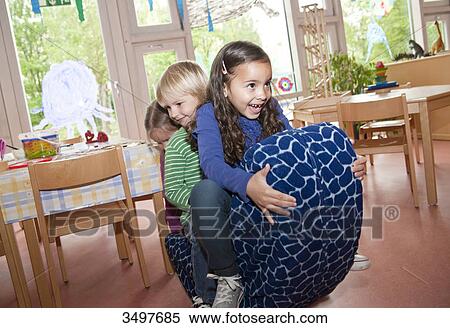 Children swinging in a kindergarten View Large Photo Image Stock Photography - Children swinging in a kindergarten . Fotosearch