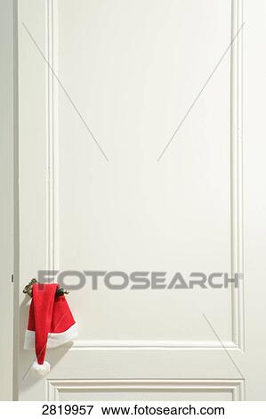 Christmas stocking hanging on handle of door View Large Photo Image Stock Photo - Christmas stocking hanging on handle of door . Fotosearch