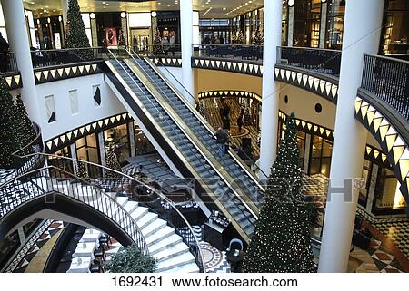 Christmas trees lit up in shopping mall View Large Photo Image Stock Image - Christmas trees lit up in shopping mall . Fotosearch
