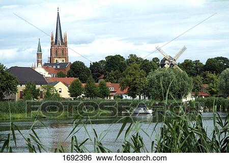 Church and houses in town View Large Photo Image Stock Photograph - Church and houses in town . Fotosearch