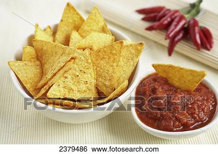 Stock Photograph - Close-up of bowls of nachos and savoury sauce . Fotosearch