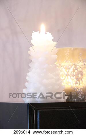 Close-up of burning candle on table View Large Photo Image Picture - Close-up of burning candle on table . Fotosearch