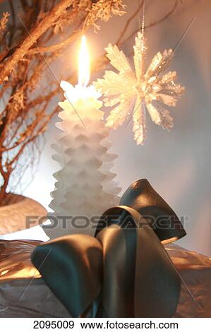 Close-up of burning candle with gift box View Large Photo Image Stock Photo - Close-up of burning candle with gift box . Fotosearch