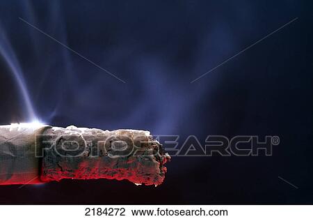 Stock Image - Close-up of burning cigarette . Fotosearch