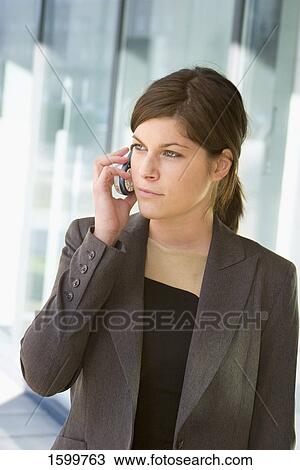 Stock Image - Close-up of businesswoman talking on mobile phone . Fotosearch