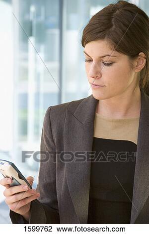 Close-up of businesswoman using mobile phone View Large Photo Image Stock Image - Close-up of businesswoman using mobile phone . Fotosearch