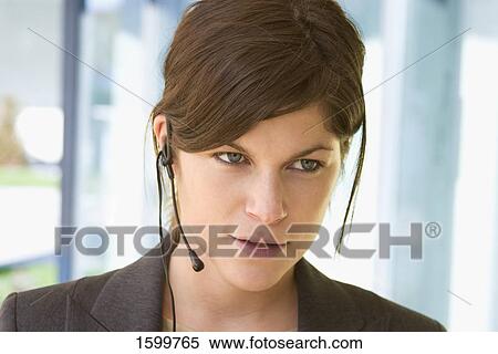 Close-up of businesswoman wearing headset View Large Photo Image Stock Photography - Close-up of businesswoman wearing headset . Fotosearch