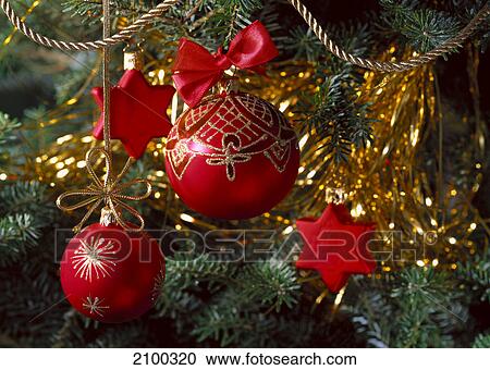 Stock Image - Close-up of Christmas balls hanging on Christmas tree . Fotosearch