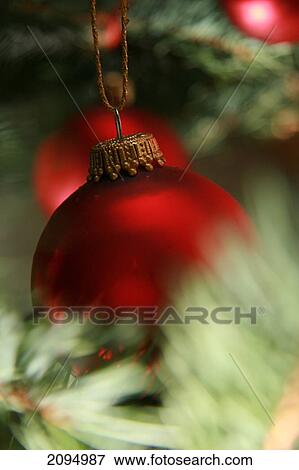 Close-up of Christmas ornaments hanging on tree View Large Photo Image Stock Photo - Close-up of Christmas ornaments hanging on tree . Fotosearch