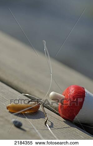 Stock Photography - Close-up of fishing equipment on wooden plank . Fotosearch