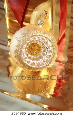 Close-up of gift box with Christmas bauble View Large Photo Image Stock Image - Close-up of gift box with Christmas bauble . Fotosearch
