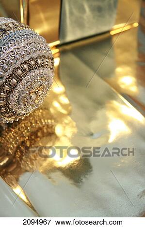 Close-up of gift box with Christmas bauble View Large Photo Image Stock Photo - Close-up of gift box with Christmas bauble . Fotosearch
