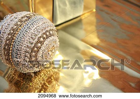 Stock Photo - Close-up of gift box with Christmas bauble . Fotosearch