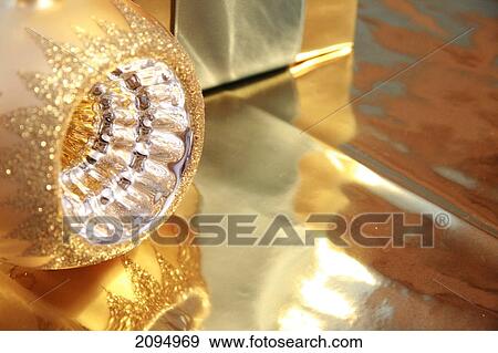Close-up of gift box with Christmas bauble View Large Photo Image Stock Photo - Close-up of gift box with Christmas bauble . Fotosearch