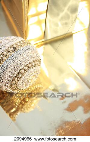 Close-up of gift box with Christmas bauble View Large Photo Image Stock Photograph - Close-up of gift box with Christmas bauble . Fotosearch