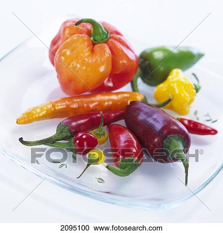 Close-up of green and red chili peppers on plate View Large Photo Image Stock Image - Close-up of green and red chili peppers on plate . Fotosearch
