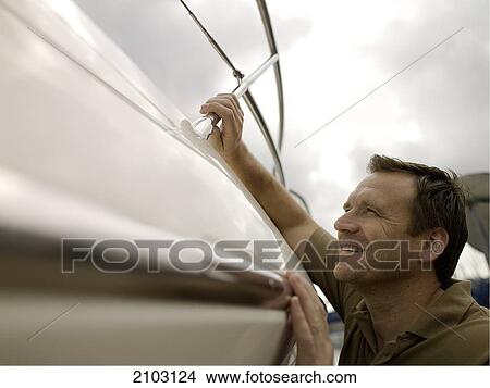 Close-up of man leaning on boat and smiling View Large Photo Image Picture - Close-up of man leaning on boat and smiling . Fotosearch