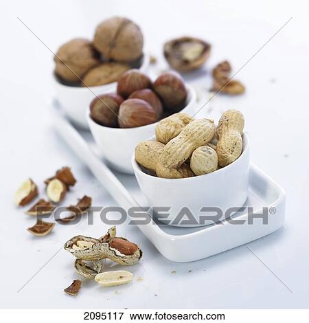 Close-up of nuts in bowls View Large Photo Image Stock Photo - Close-up of nuts in bowls . Fotosearch
