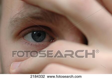 Close-up of person through fingers  View Large Photo Image Stock Image - Close-up of person through fingers . Fotosearch