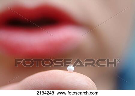 Close-up of pill on finger View Large Photo Image Stock Photo - Close-up of pill on finger . Fotosearch