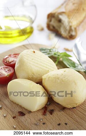 Close-up of potatoes with tomato on cutting board View Large Photo Image Picture - Close-up of potatoes with tomato on cutting board . Fotosearch