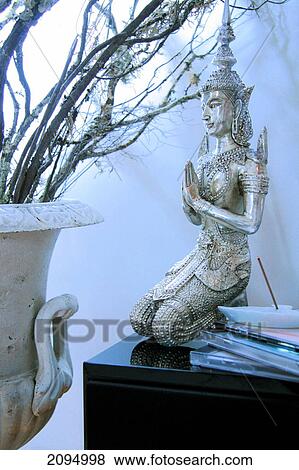Close-up of praying sculpture on table View Large Photo Image Stock Photo - Close-up of praying sculpture on table . Fotosearch