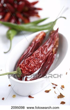 Stock Photo - Close-up of red chili peppers in cup . Fotosearch