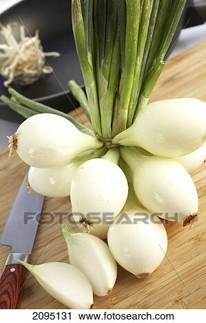 Close-up of spring onions and knife on table View Large Photo Image Stock Image - Close-up of spring onions and knife on table . Fotosearch