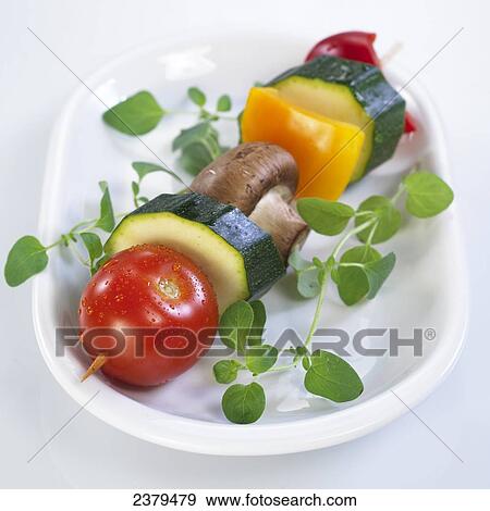 Stock Photo - Close-up of tomato with mushroom and bell pepper in tray . Fotosearch