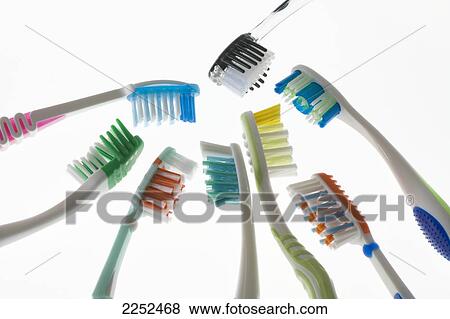 Close-up of toothbrushes against white background View Large Photo Image Stock Photo - Close-up of toothbrushes against white background . Fotosearch