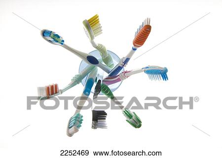 Stock Photo - Close-up of toothbrushes in glass . Fotosearch