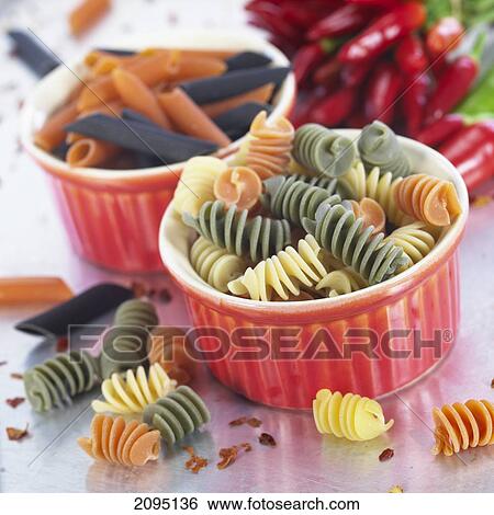 Stock Photograph - Close-up of two bowls of pasta and red chili peppers . Fotosearch