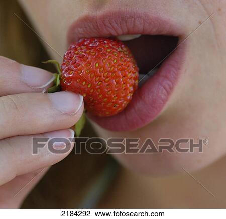 Close-up of woman eating strawberry View Large Photo Image Stock Image - Close-up of woman eating strawberry . Fotosearch