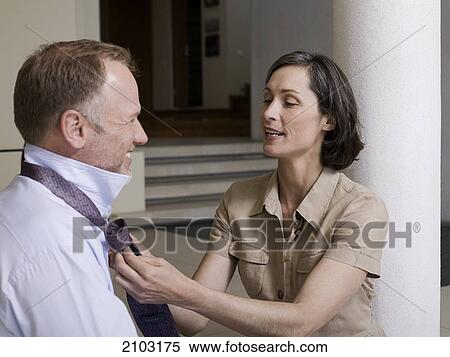Close-up of woman tying her husband's tie View Large Photo Image Stock Photography - Close-up of woman tying her husband's tie . Fotosearch