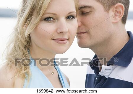 Close-up of young couple romancing  View Large Photo Image Stock Image - Close-up of young couple romancing . Fotosearch