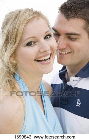 Close-up of young couple smiling View Large Photo Image Stock Image - Close-up of young couple smiling . Fotosearch