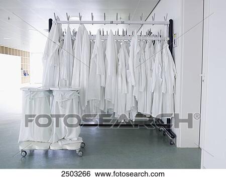 Stock Photograph - Clothes hanging on hangers . Fotosearch