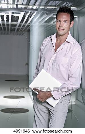 Confident businessman holding documents View Large Photo Image Stock Photograph - Confident businessman holding documents . Fotosearch
