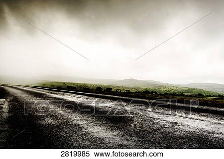 Country road passing through field in fog, Dartmoor, Devon, England View Large Photo Image Stock Photography - Country road passing through field in fog, Dartmoor, Devon, England . Fotosearch