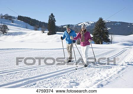 Picture - Couple cross-country skiing, Tannheimer Tal, Tyrol, Austria . Fotosearch