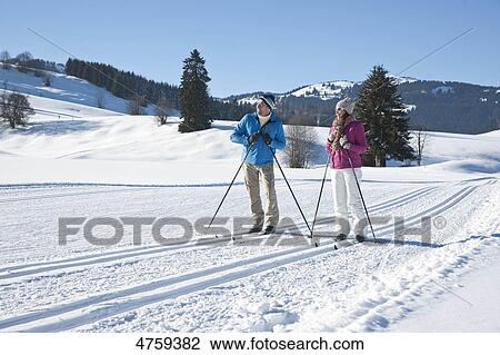 Stock Image - Couple cross-country skiing, Tannheimer Tal, Tyrol, Austria . Fotosearch