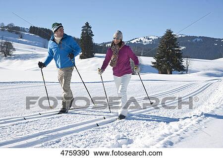 Stock Image - Couple cross-country skiing, Tannheimer Tal, Tyrol, Austria . Fotosearch