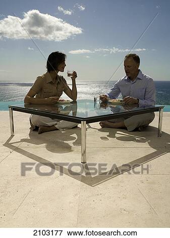 Couple having food at table View Large Photo Image Stock Photo - Couple having food at table . Fotosearch