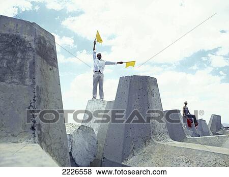 Couple holding flags at coast View Large Photo Image Stock Photo - Couple holding flags at coast . Fotosearch